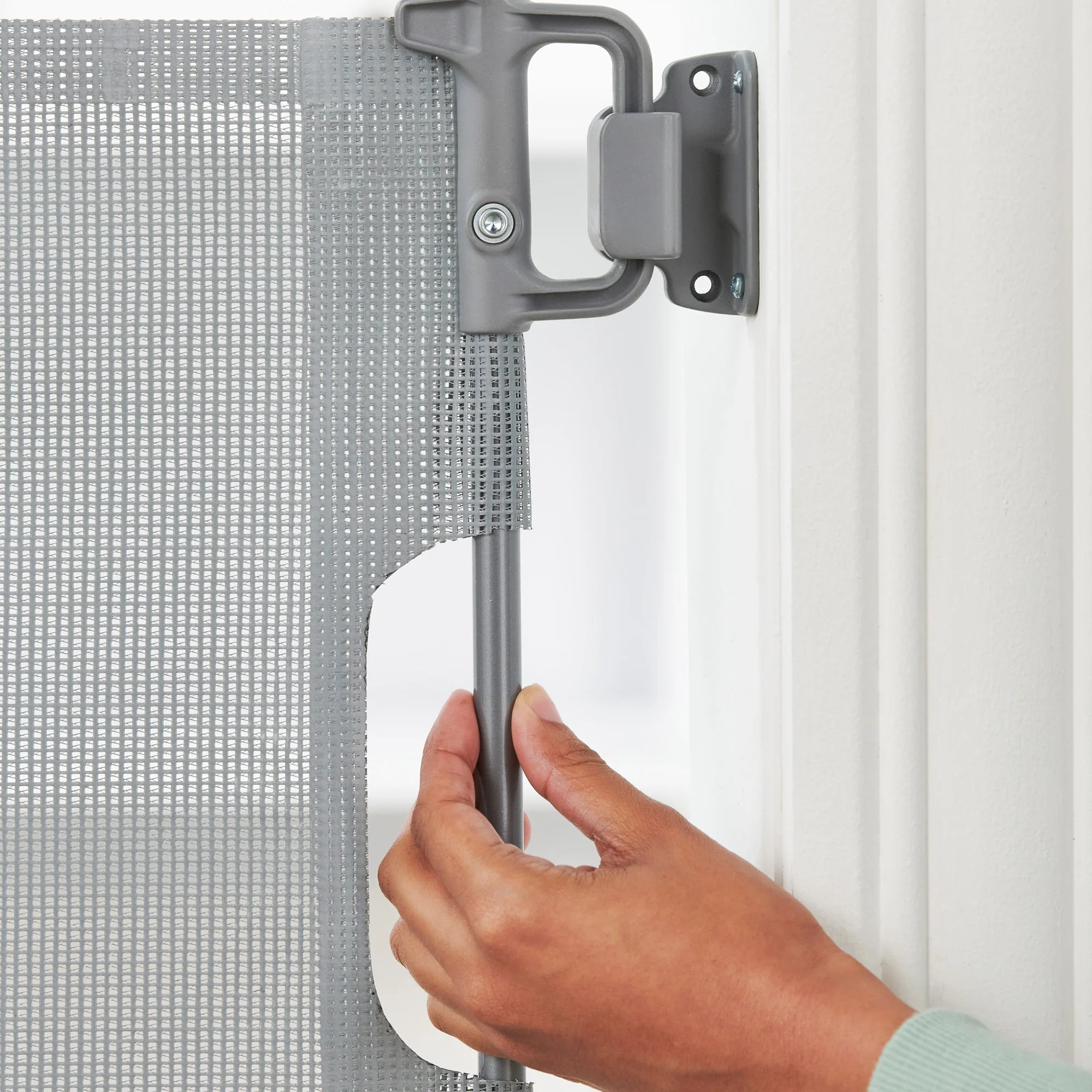 The Carlson Retractable Pet Gate expands up to 50" wide, stands 30" tall, and features a high-quality mesh barrier for pet safety.
