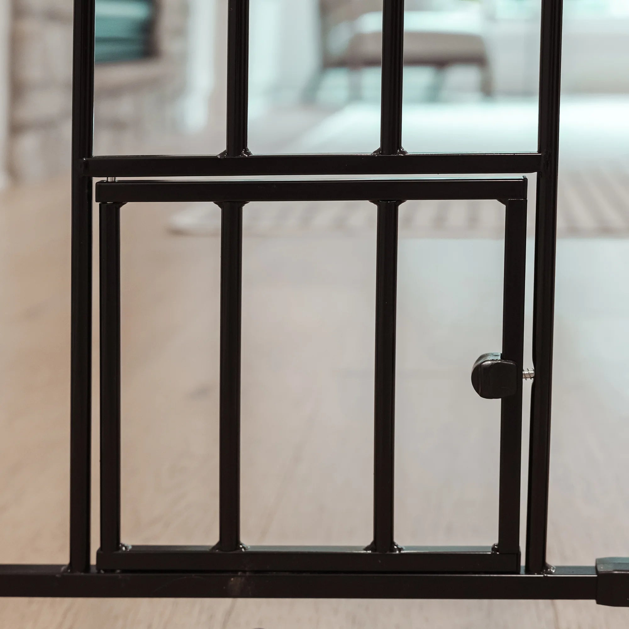Black Carlson 36” Extra Tall Walk-Thru Pet Gate with small pet door is a durable, chew-proof solution for securing your home. Made from 100% steel, it's perfect for larger or active dogs. The gate features a 16.5” wide walk-through door and includes a 4” extension for wider openings.