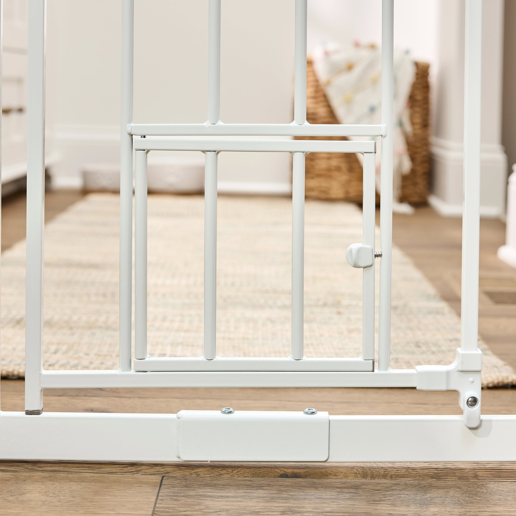 The Carlson 36” Extra Tall Walk-Thru Pet Gate with Small Pet Door in white, made of durable steel, is designed to keep pets safely contained. It features a 36” height, expandable width (29” to 36.5”), easy walk-through door, and a small pet door for small animals to pass through while keeping larger pets confined.
