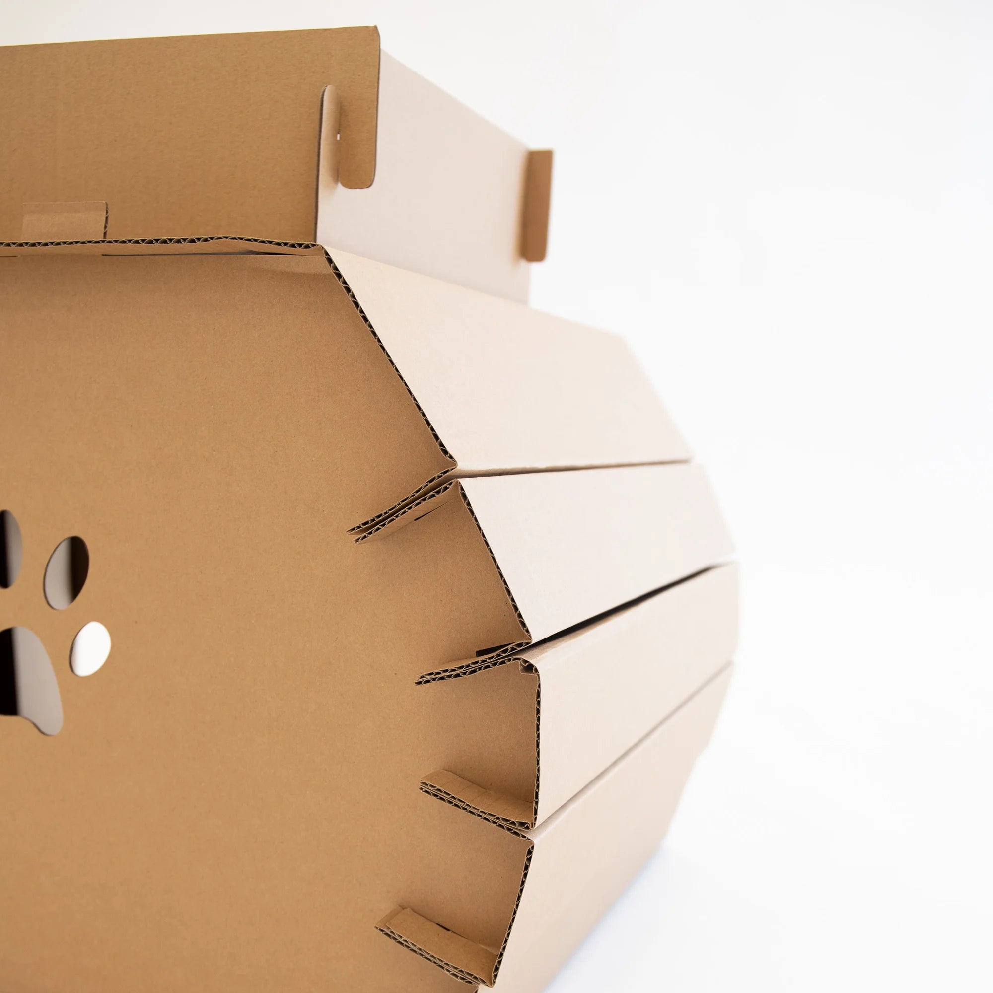 The Carlson Cat Camper and Scratcher is a compact, eco-friendly playhouse made from durable cardboard. Featuring a cat door, three paw-shaped windows, and a removable scratcher, it provides a cozy, entertaining space for small animals like cats and rabbits. Easy to assemble and lightweight for easy transport.