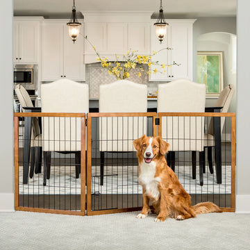 Dog sitting in front of Design Paw Tall 3 Panel Wooden Pet Gate in dining room.