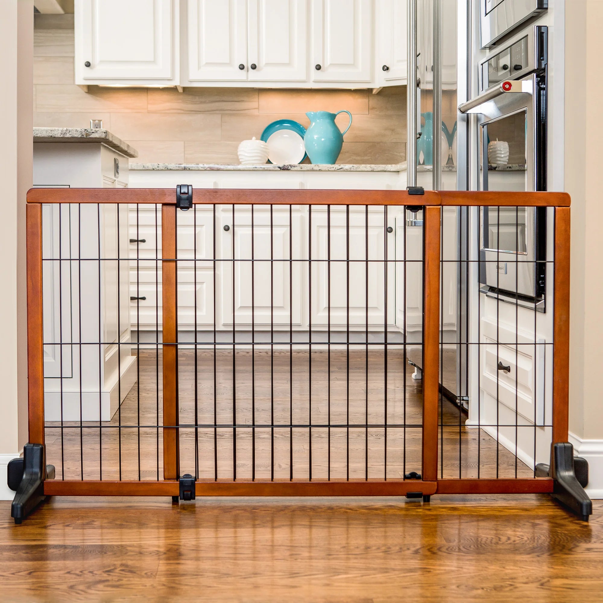 The Carlson Design Paw Extra Tall Extra Wide Freestanding Pet Gate features a durable wood frame with black steel accents, expanding from 40” to 70” in width. Standing 28” tall, it’s perfect for small pets, offering a non-permanent, easy-to-use solution to manage pet access in your home.