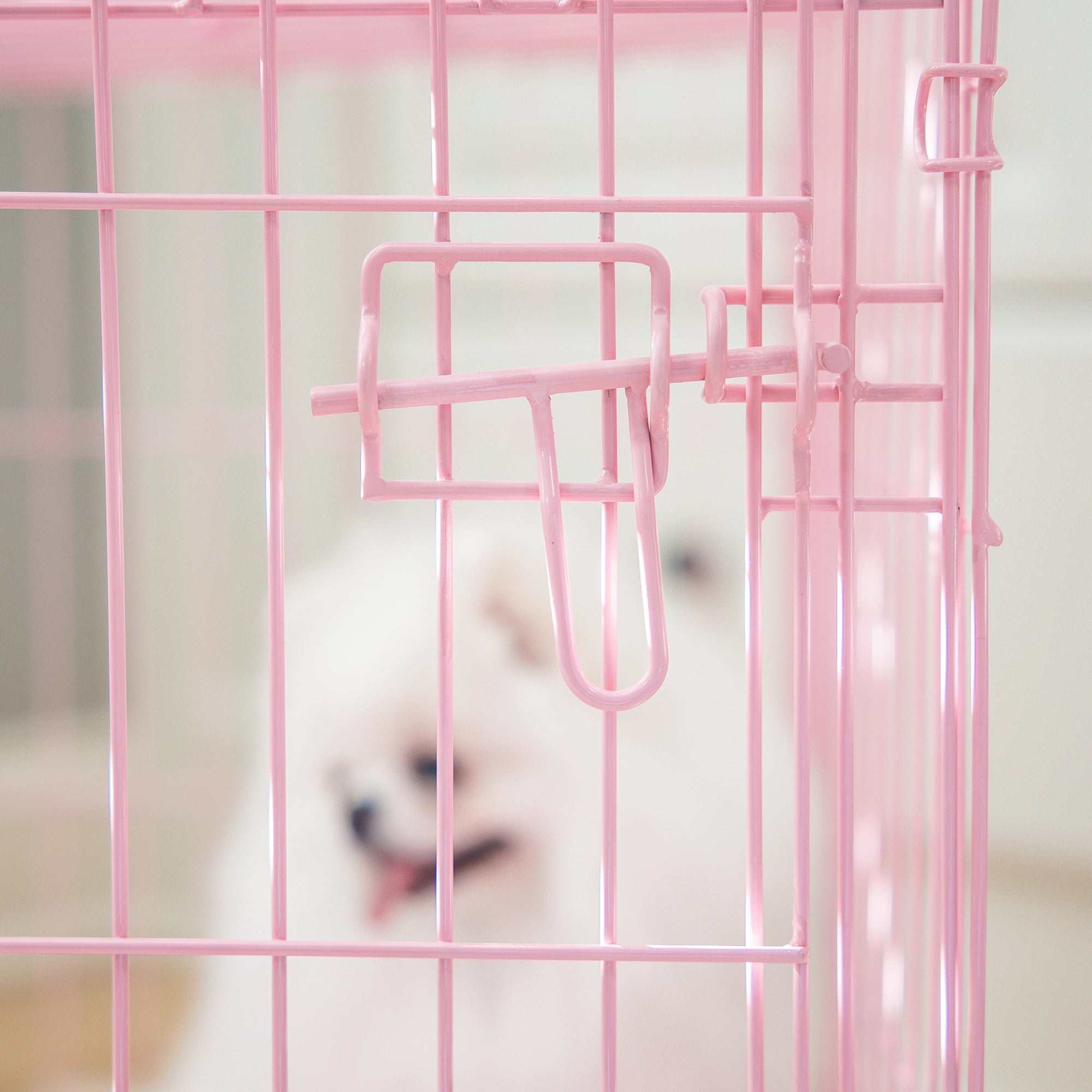 The Carlson Small Single-Door Dog Crate in pink is a durable steel wire kennel measuring 24” L x 18” W x 20.5” H. It features a multi-point locking system, a front door for easy access, and a removable bottom pan for easy cleaning. The crate folds nearly flat for convenient travel and storage. Ideal for small dogs.