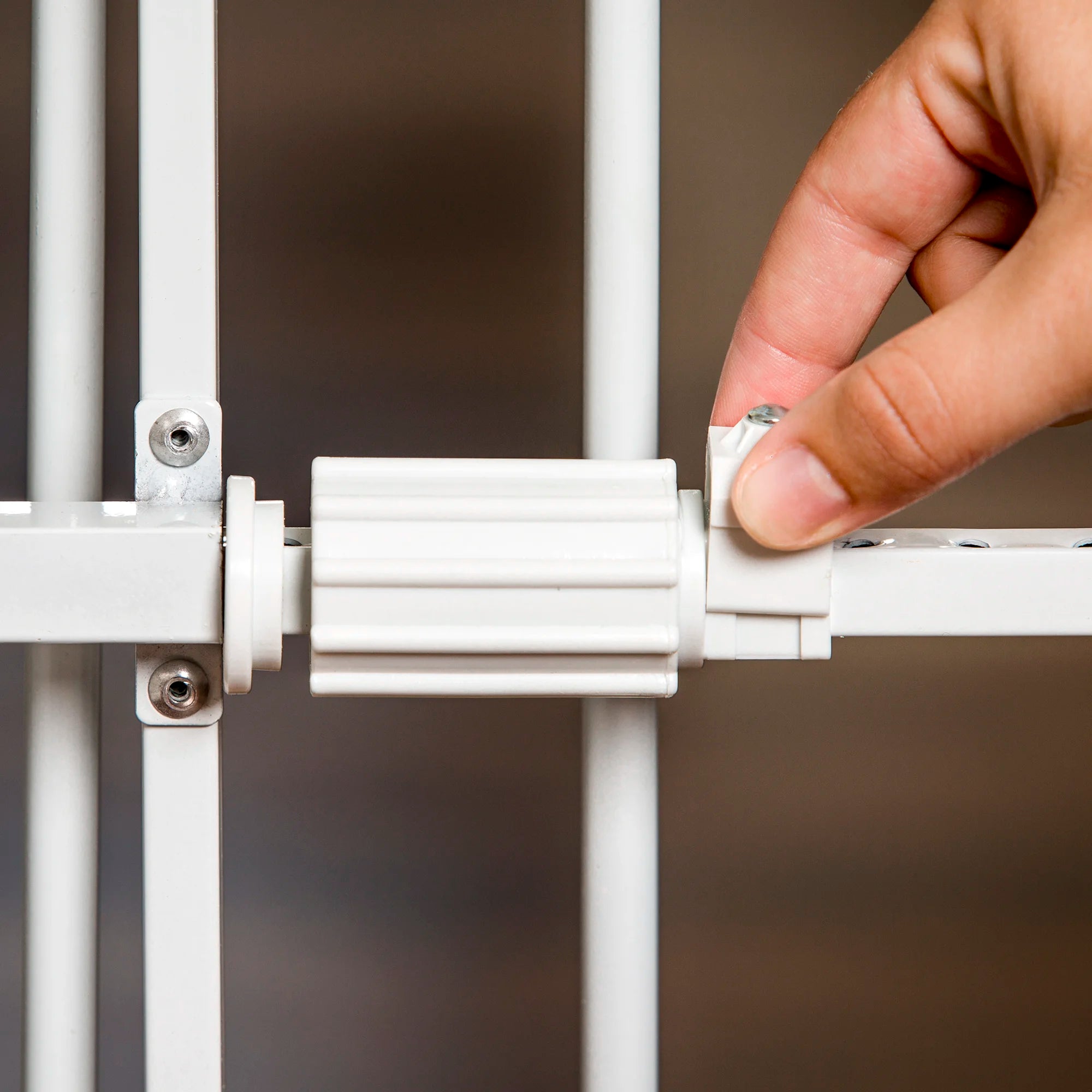 Carlson Tuffy® Expandable Pet Gate in white, durable steel frame, pressure-mounted, adjustable 26"-38", with small pet door for easy access.