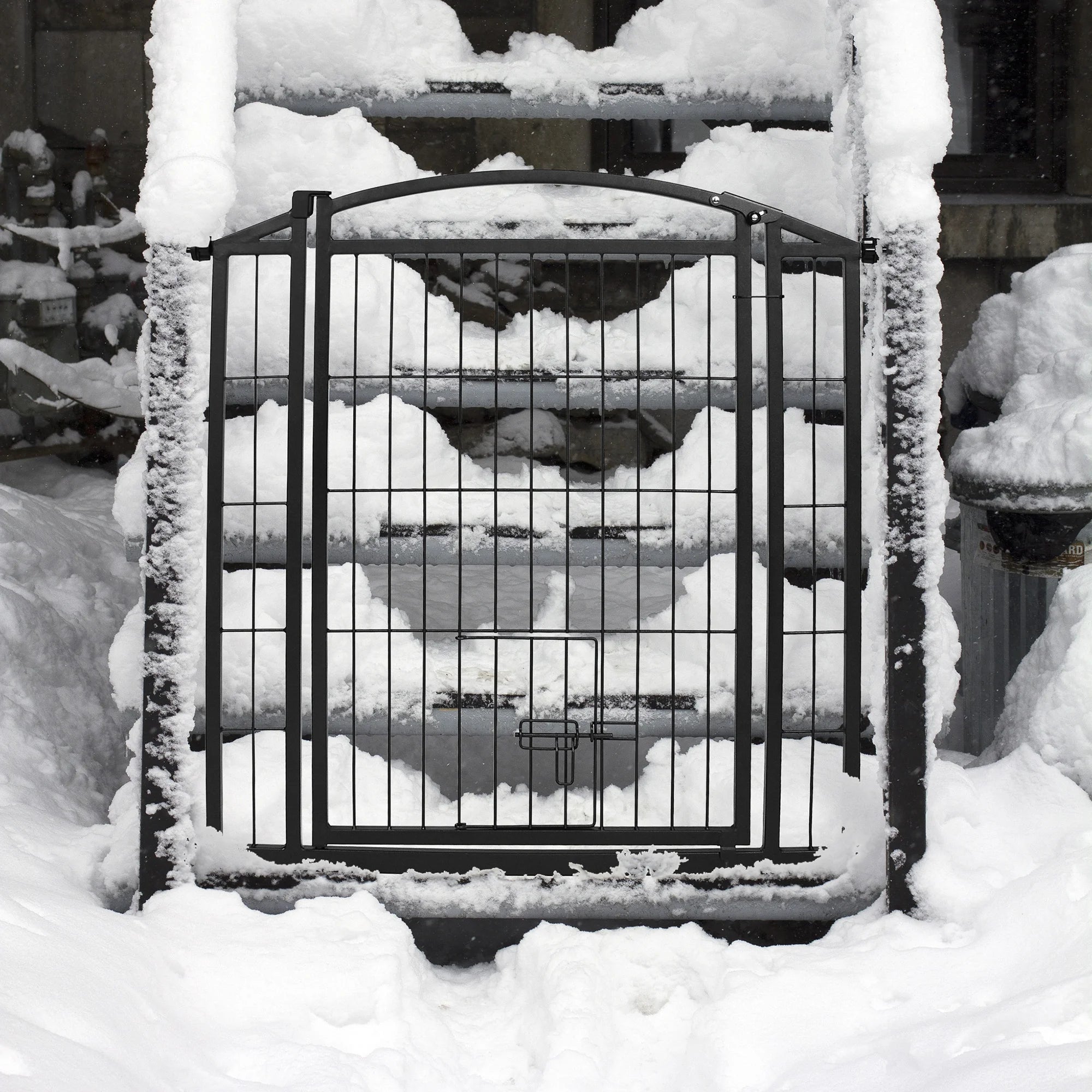 Outdoor Walk-Thru Pet Gate set up on a snowy staircase.