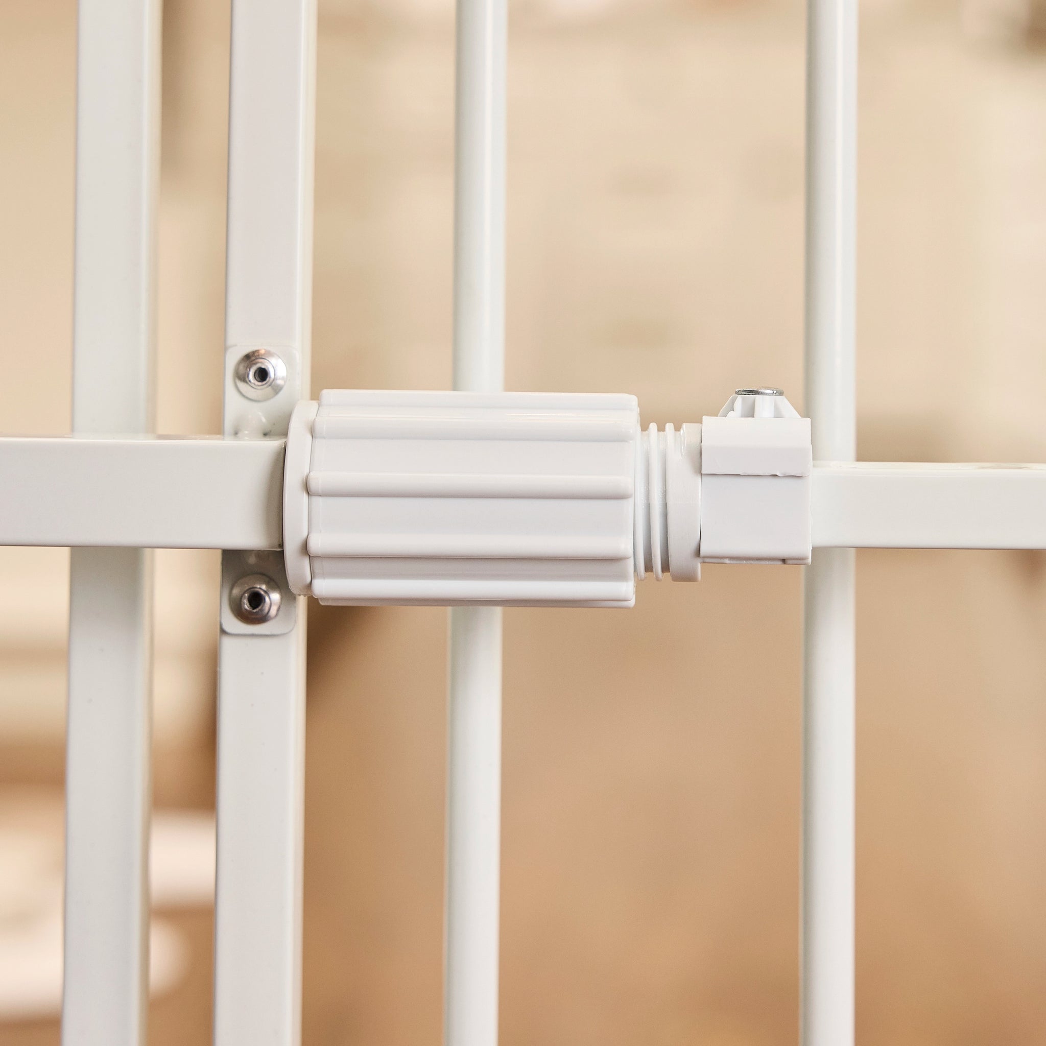 Close-up of a white metal gate with a beige background