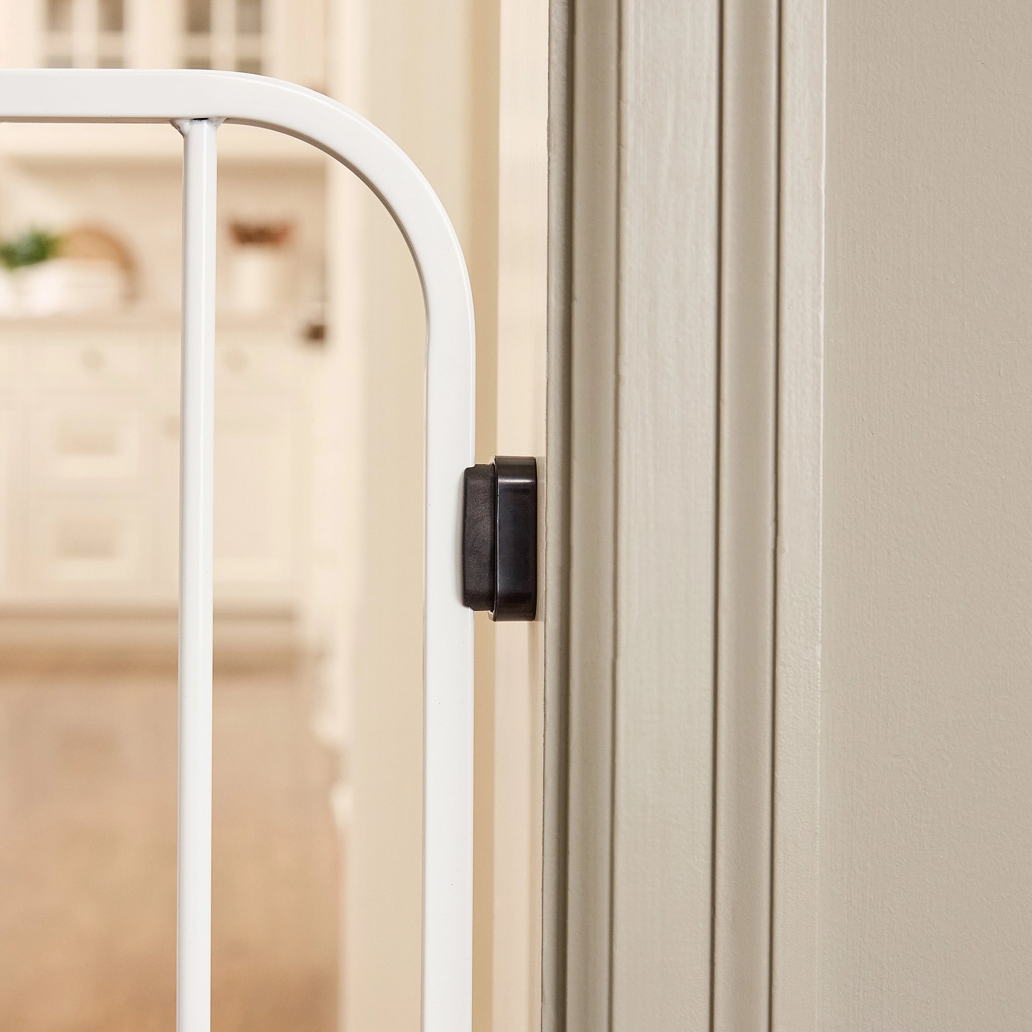 White gate on a beige wall.