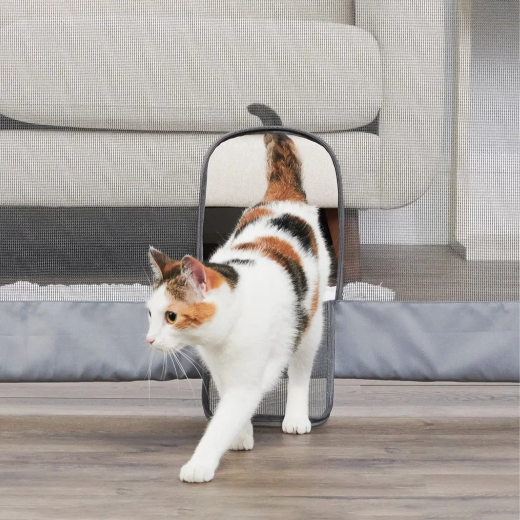 Cat walking through Small Pet Door on Expandable Mesh Pet Gate.