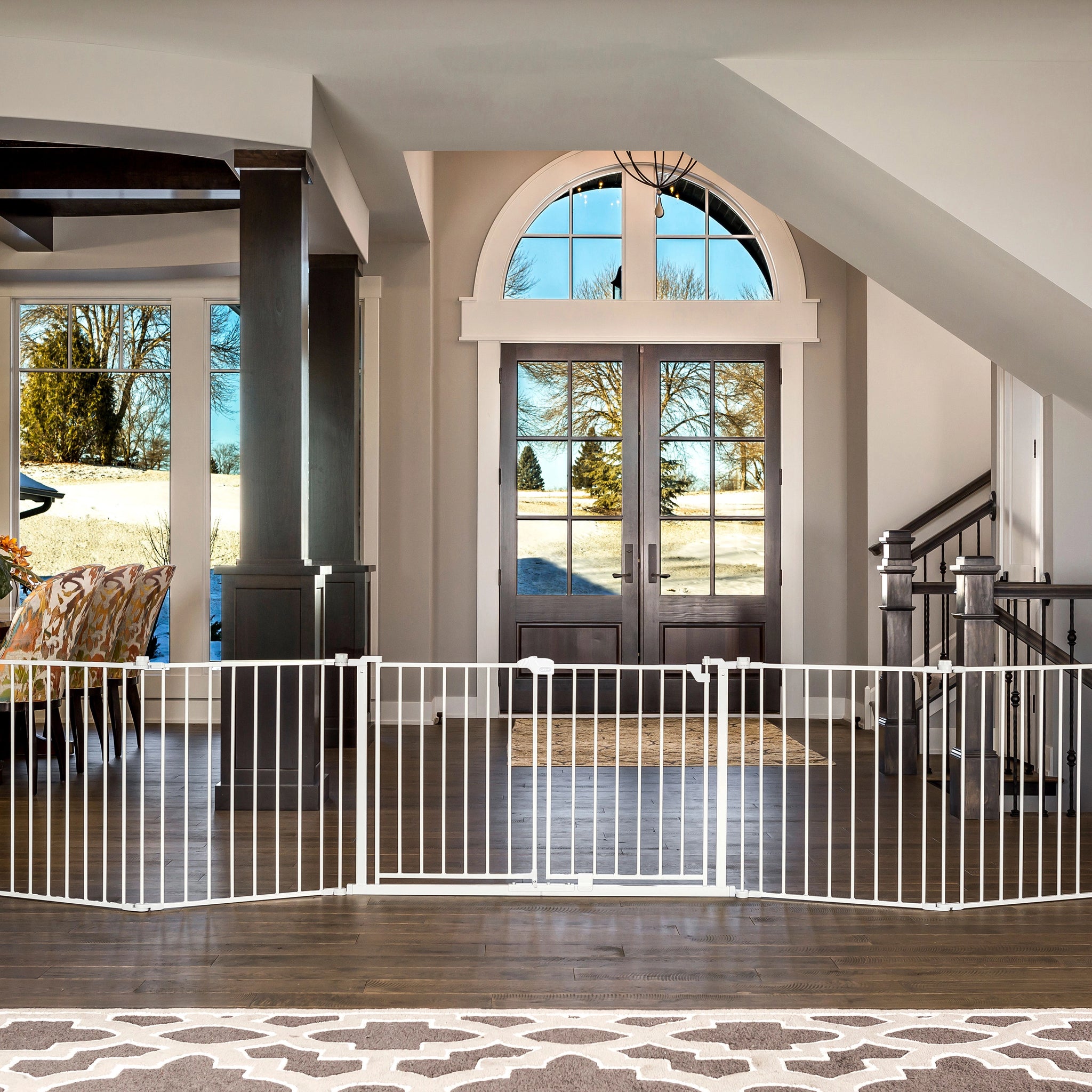 Modern home interior with a white baby gate in the foreground.