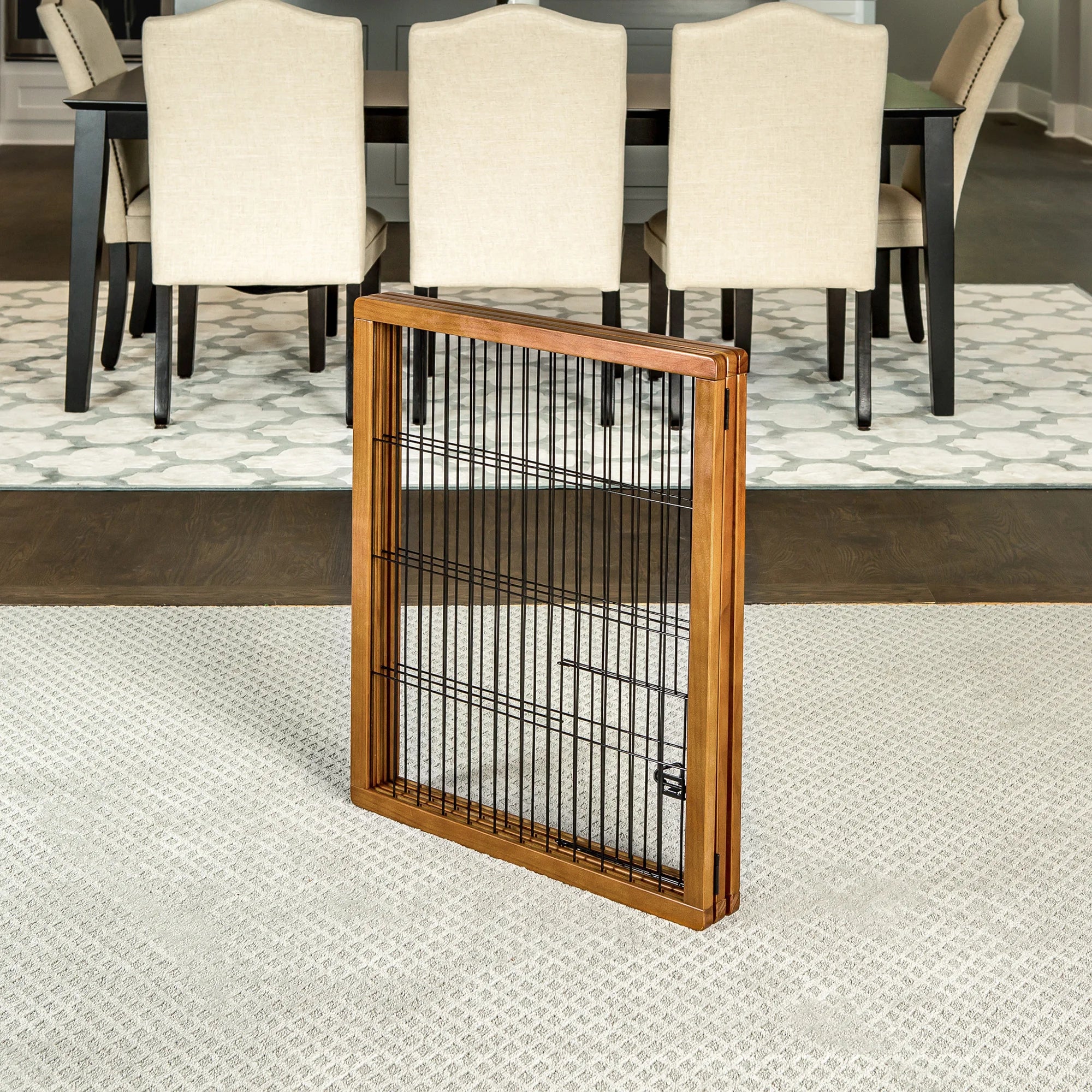 Folded version of the Design Paw Tall 3 Panel Wooden Pet Gate in a dining room.