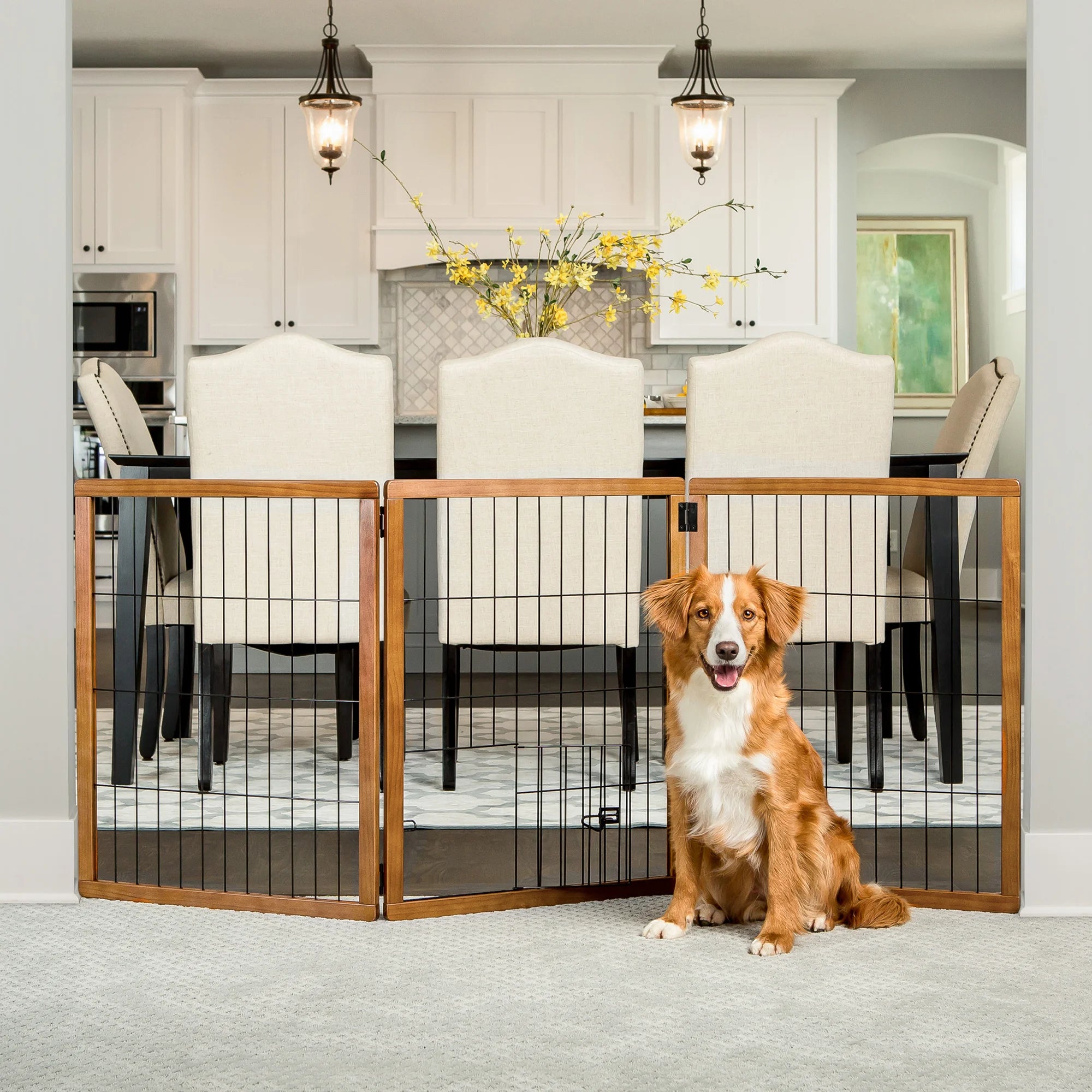 A dog sitting in a dining room in front of the Design Paw Tall 3 Panel Wooden Pet Gate.