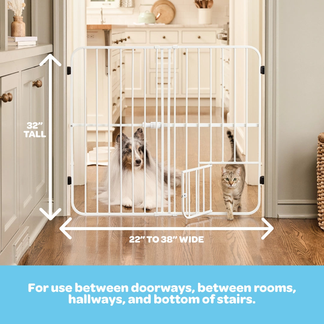 White pet gate with dimensions in a home setting, showing two dogs using it.